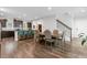An open concept dining room, connected to kitchen, features hardwood floors and neutral paint at 3255 Morgan Rd, Buford, GA 30519