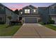 Charming two-story home with a gray garage door, stone accents, and a well-manicured lawn at 3255 Morgan Rd, Buford, GA 30519