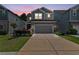 Charming two-story home featuring a stone facade, neutral color palette, well-manicured lawn, and an attached two-car garage at 3255 Morgan Rd, Buford, GA 30519