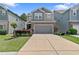 Charming two-story home featuring a stone facade, neutral color palette, well-manicured lawn, and an attached two-car garage at 3255 Morgan Rd, Buford, GA 30519