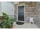 Welcoming front door framed by stone accents, black hardware and potted plants on the porch at 3255 Morgan Rd, Buford, GA 30519