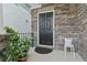 Inviting front door with a stone facade, black door and potted plants on the front porch at 3255 Morgan Rd, Buford, GA 30519