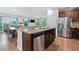An open concept kitchen with stainless appliances, granite countertops, and views to the dining room at 3255 Morgan Rd, Buford, GA 30519