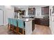 Kitchen with granite counters, stainless steel appliances, dark wood cabinets and central island with bar stool seating at 3255 Morgan Rd, Buford, GA 30519