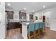 This kitchen offers a center island with seating and granite countertops and lots of storage at 3255 Morgan Rd, Buford, GA 30519