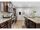 A galley style kitchen features granite counters, stainless appliances and ample storage space at 3255 Morgan Rd, Buford, GA 30519
