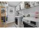 Organized laundry room equipped with modern washer and dryer, plus ample storage for supplies and linens at 3255 Morgan Rd, Buford, GA 30519
