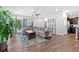 Bright living room featuring a large sectional sofa, ceiling fan, and hardwood floors at 3255 Morgan Rd, Buford, GA 30519