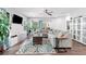 Bright living room featuring a large sectional sofa, ceiling fan, and hardwood floors at 3255 Morgan Rd, Buford, GA 30519