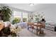 Bright office space with large window, potted plants, a sofa and desk, creating an inspiring and functional workspace at 3255 Morgan Rd, Buford, GA 30519
