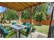 Enjoyable outdoor patio with a dining set and green furniture overlooking the well-kept lawn at 3255 Morgan Rd, Buford, GA 30519