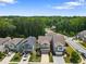 Wide shot of a neighborhood street with multiple homes and green trees in the background at 3255 Morgan Rd, Buford, GA 30519