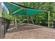 Shaded swing set and playground area with protective canopy, within fenced community space at 3255 Morgan Rd, Buford, GA 30519
