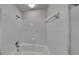 Tiled shower over tub featuring tile surround and modern fixtures at 3284 Salem Se Ln, Conyers, GA 30013