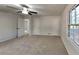 Spacious bedroom featuring neutral carpet, a ceiling fan, and natural light from a large window at 3284 Salem Se Ln, Conyers, GA 30013