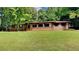 Charming single-story brick home with a lush green lawn and mature trees at 3284 Salem Se Ln, Conyers, GA 30013