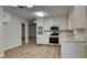 Bright kitchen featuring white cabinets, stainless steel appliances, and vinyl floors at 3284 Salem Se Ln, Conyers, GA 30013