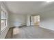 Bright living room featuring large window, carpet, and wainscotting at 3284 Salem Se Ln, Conyers, GA 30013