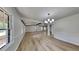 Open concept living room with a modern chandelier, sleek floors, and neutral paint at 3284 Salem Se Ln, Conyers, GA 30013