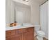 Bathroom with a white sink, brown wood cabinets, and a standard toilet and shower with curtain at 5711 Keys Way, Lithonia, GA 30058