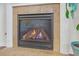 Fireplace with stone surround and hearth; gas logs burning with blue flame at 5711 Keys Way, Lithonia, GA 30058