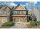Inviting two-story brick townhome with a two-car garage and a well-manicured lawn at 5711 Keys Way, Lithonia, GA 30058