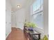 Bright hallway with hardwood floors, white trim, and ample natural light from the large window at 5711 Keys Way, Lithonia, GA 30058