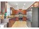 Spacious kitchen with stainless steel appliances, granite countertops, and tile flooring at 5711 Keys Way, Lithonia, GA 30058