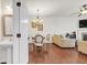 Open-concept living space with hardwood floors, chandelier, fireplace, and neutral decor at 5711 Keys Way, Lithonia, GA 30058