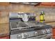 Stainless steel stove top with granite counter tops and tile backsplash at 5711 Keys Way, Lithonia, GA 30058