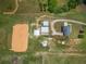 Aerial view of farm featuring well-kept equestrian facilities, barns, and a large riding arena at 654 Euharlee Five Forks Rd, Kingston, GA 30145