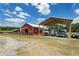 Barn featuring red paint and a metal roof, a trailer with a truck and other storage facilities at 654 Euharlee Five Forks Rd, Kingston, GA 30145