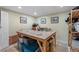 Finished basement featuring tile flooring, a large wood table and blue storage containers at 654 Euharlee Five Forks Rd, Kingston, GA 30145