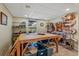 Finished basement with tile flooring and a large wood table surrounded by storage containers and shelving at 654 Euharlee Five Forks Rd, Kingston, GA 30145
