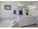 Bathroom featuring a double vanity with a wide mirror, cabinets and drawers, and a large tub at 654 Euharlee Five Forks Rd, Kingston, GA 30145