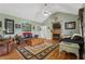 Cozy living room with a fireplace, hardwood floors, and comfortable leather seating at 654 Euharlee Five Forks Rd, Kingston, GA 30145