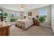 Bright bedroom featuring a ceiling fan, natural light from large windows and charming rustic accents at 654 Euharlee Five Forks Rd, Kingston, GA 30145