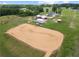 Large outdoor horse riding arena surrounded by farm buildings, offering ample space for equestrian activities at 654 Euharlee Five Forks Rd, Kingston, GA 30145