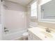 Bathroom with white fixtures including a shower-tub combo, toilet, and sink at 1416 Emerald Pine Ct, Lawrenceville, GA 30043