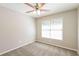 Cozy bedroom with carpet floors, a ceiling fan, and a large window at 1416 Emerald Pine Ct, Lawrenceville, GA 30043
