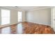 Bedroom with hardwood floors, neutral paint, trim, and two windows that provide natural light at 1416 Emerald Pine Ct, Lawrenceville, GA 30043