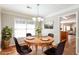 Cozy dining room with a round table set for four, adjacent to the living area at 1416 Emerald Pine Ct, Lawrenceville, GA 30043