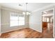 Inviting dining room with wood floors and a view to the kitchen at 1416 Emerald Pine Ct, Lawrenceville, GA 30043