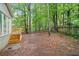 Backyard with wooded border, stairs leading to deck at 175 River Run, Roswell, GA 30075