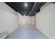 This unfinished basement features white wainscoting and a painted, exposed ceiling with vents at 175 River Run, Roswell, GA 30075