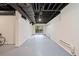 Finished basement featuring white paneling and an exposed ceiling at 175 River Run, Roswell, GA 30075