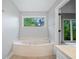Bathroom features a soaking tub, natural light, and modern fixtures at 175 River Run, Roswell, GA 30075