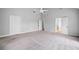 Large main bedroom with carpet flooring, ceiling fan, and multiple access doors at 175 River Run, Roswell, GA 30075