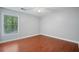 Comfortable bedroom with a large window providing natural light and views of the surrounding greenery at 175 River Run, Roswell, GA 30075