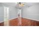 Bedroom has wood floors and view into ensuite bathroom at 175 River Run, Roswell, GA 30075